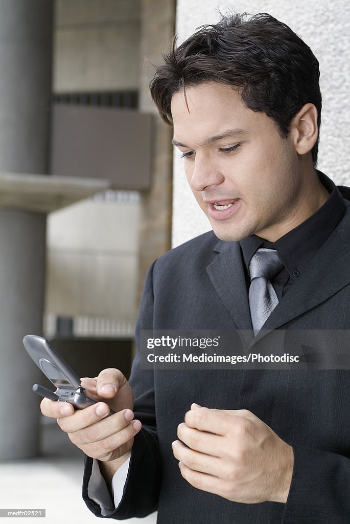 Close-up of a young man using a mobile phone