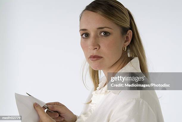 young woman opening an envelope - ペーパーナイフ ストックフォトと画像