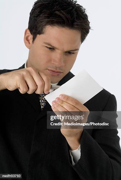 businessman opening letter with letter opener - letter opener stock pictures, royalty-free photos & images