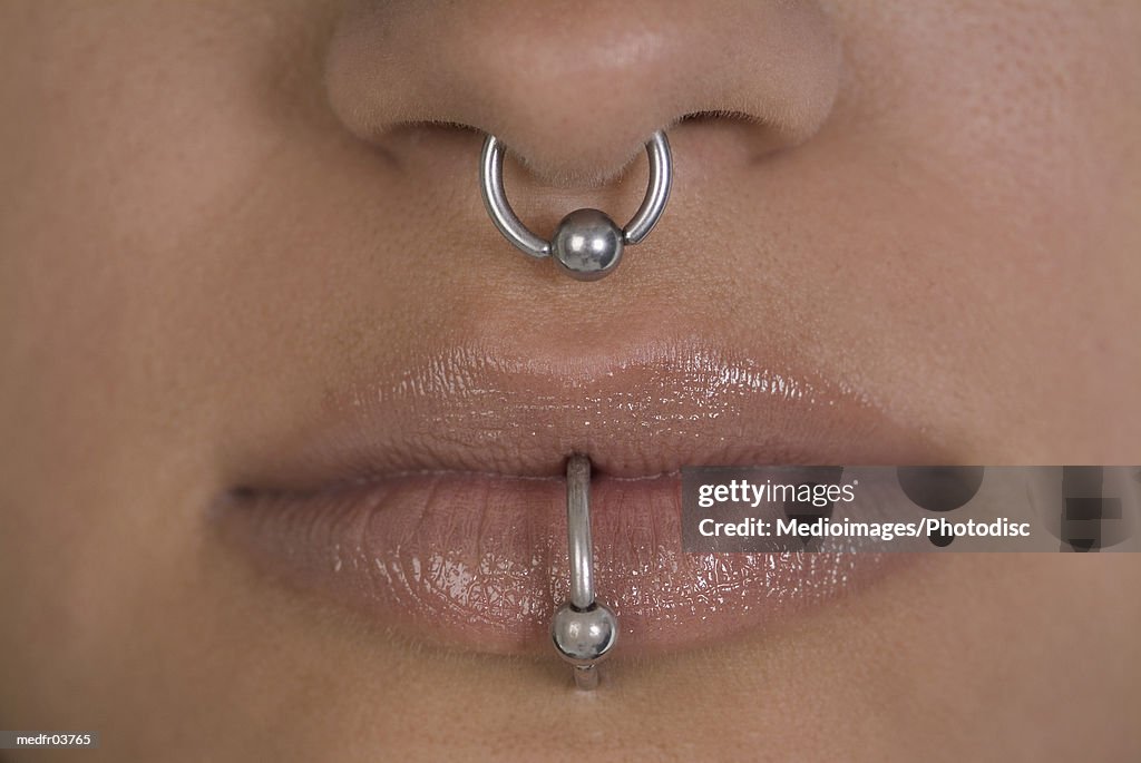 Close-up of a woman's nose and mouth with piercing