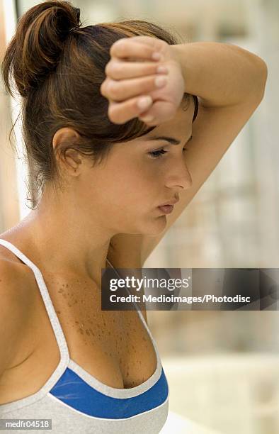 young woman with hand on head - hand on head foto e immagini stock