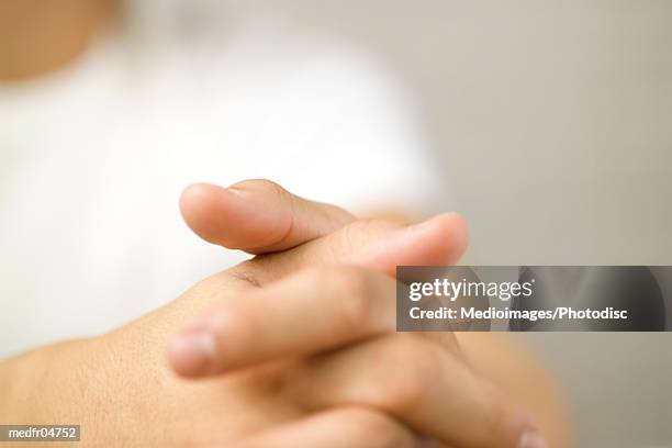 person with fingers interlocked - interlocking fingers stock pictures, royalty-free photos & images