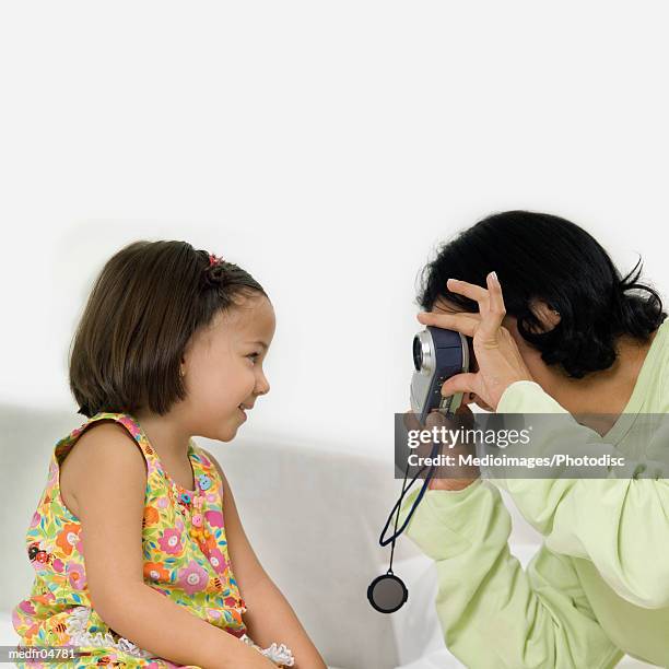 mother taking picture of her three year old daughter, close-up - year on year stock pictures, royalty-free photos & images