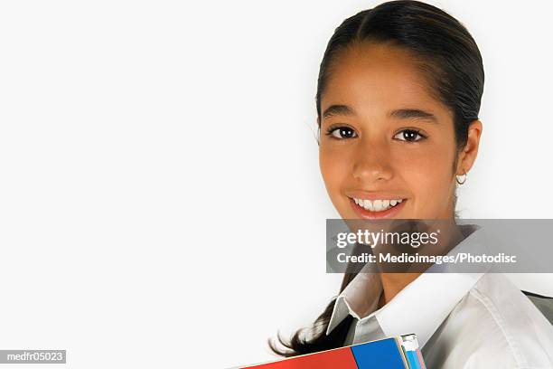 smiling twelve year old girl holding books, close-up, part of - year on year stock pictures, royalty-free photos & images