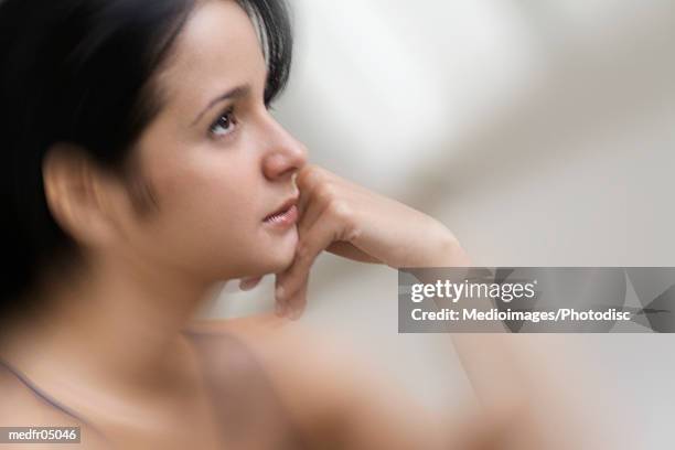 side profile of a young woman looking ahead - ahead stock pictures, royalty-free photos & images