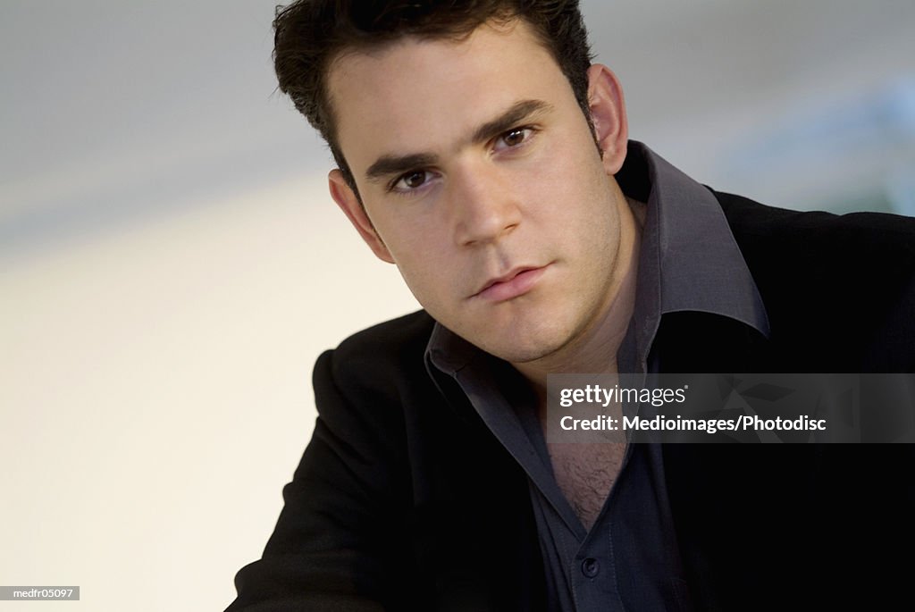 Portrait of serious young businessman, close-up