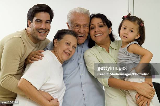 portrait of grandparents with a young couple and their granddaughter - pareja de mediana edad fotografías e imágenes de stock