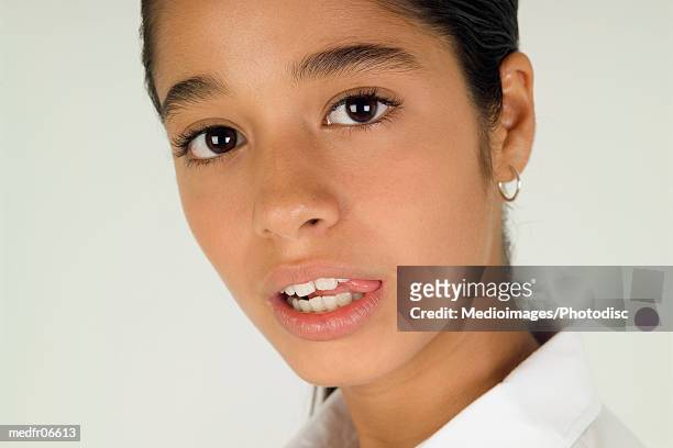 portrait of twelve year old girl with tongue between teeth, close-up - year on year stock pictures, royalty-free photos & images