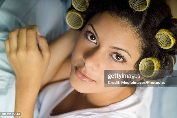 young woman with curlers in hair, close-up - hair curlers stockfoto's en -beelden