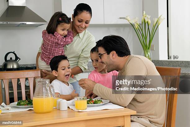 family of five having lunch or dinner - lili gentle fotografías e imágenes de stock