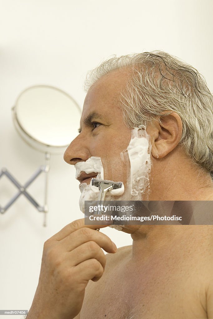 Senior man shaving