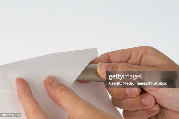 person opening letter with letter opener, close-up - ペーパーナイフ ストックフォトと画像