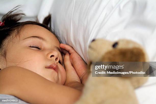 three year old sleeping with stuffed dog, close-up - year on year stock pictures, royalty-free photos & images