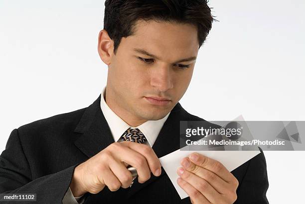 businessman opening letter with letter opener, close-up - letter opener stock pictures, royalty-free photos & images