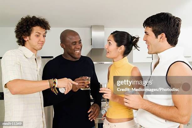 four friends in a kitchen with drinks - female with group of males stock pictures, royalty-free photos & images