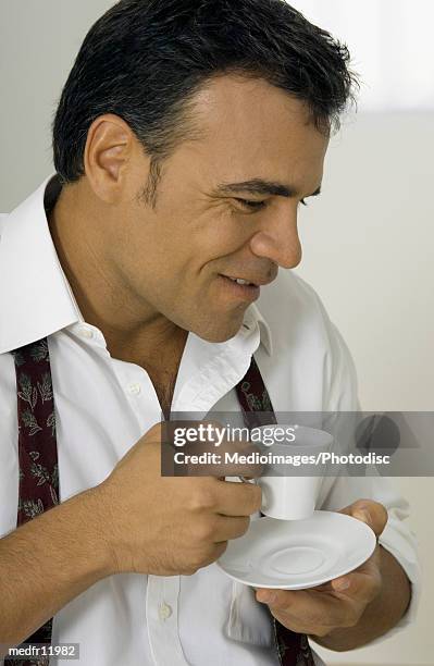 side profile of a man holding a cup and saucer - untied stock pictures, royalty-free photos & images
