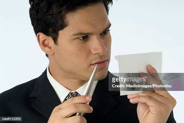 surprised businessman opening letter with letter opener - letter opener stock pictures, royalty-free photos & images