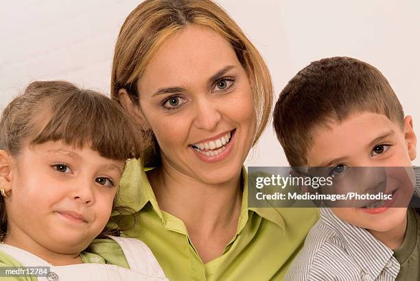 smiling woman and two children, close-up - hazel bond fotografías e imágenes de stock