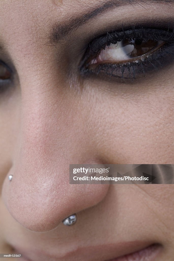 Close-up of a young woman's facial piercing