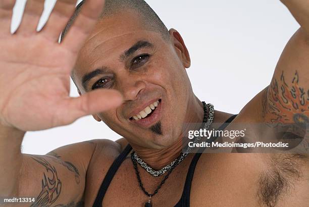 man raising his tattooed arms - soul patch stock pictures, royalty-free photos & images