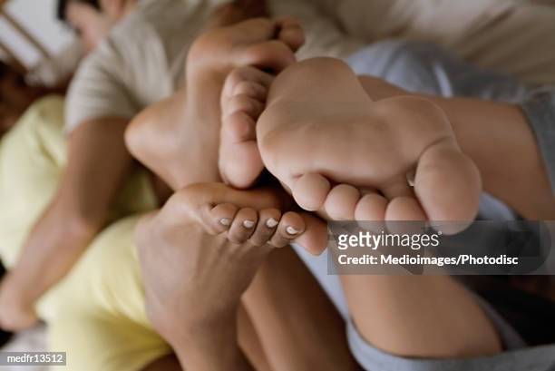 high angle view of a young couple - woman lying on stomach with feet up fotografías e imágenes de stock