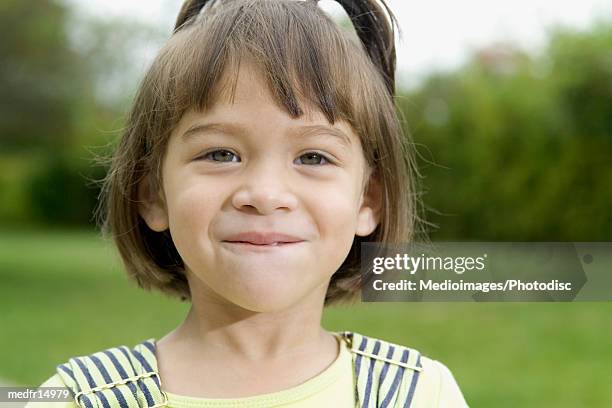 portrait of smiling four year old girl outdoors, close-up - marvista entertainment parkside pictures with the cinema society host a screening of the year of spectacular men after party stockfoto's en -beelden