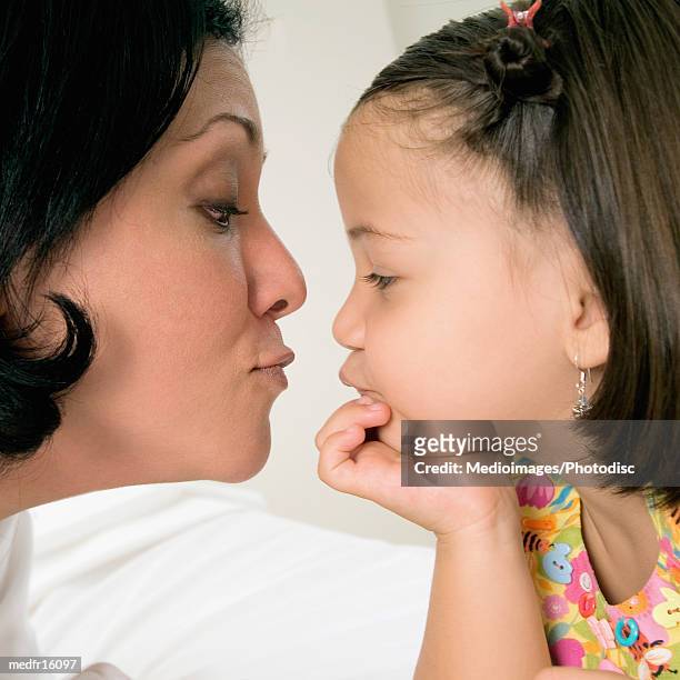 mother hugging three year old daughter, close-up - year on year stock pictures, royalty-free photos & images
