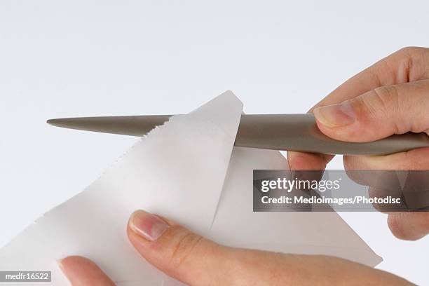 person opening letter with letter opener, close-up - letter opener stock pictures, royalty-free photos & images