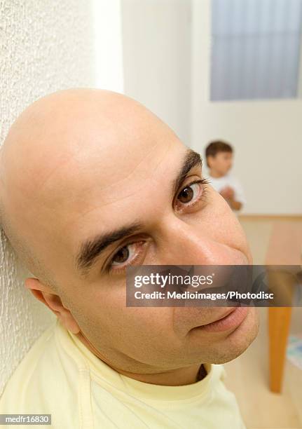 bald man looking back over shoulder - bald stock-fotos und bilder