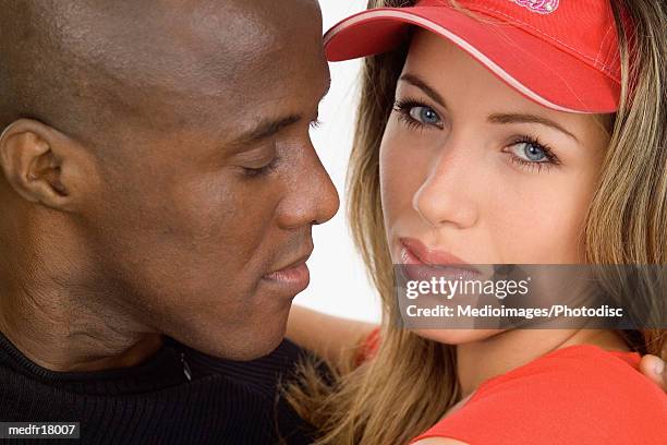 bald man and woman wearing red cap, close-up - bald stock-fotos und bilder