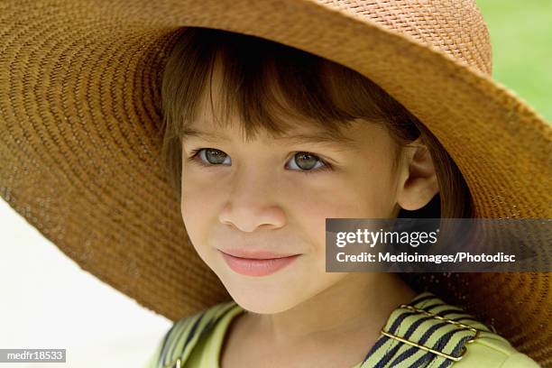 six year old girl wearing straw hat, close-up - year on year stock pictures, royalty-free photos & images