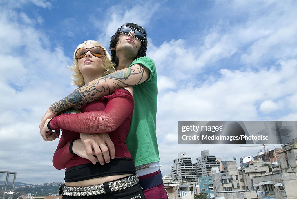 Low angle view of a young couple standing together looking ahead