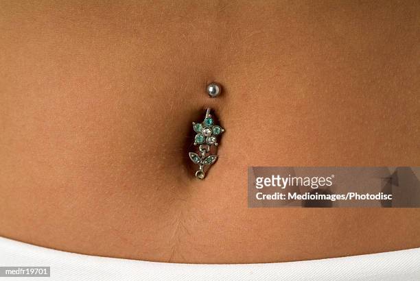 close-up of a piercing in the navel - body modification stock-fotos und bilder