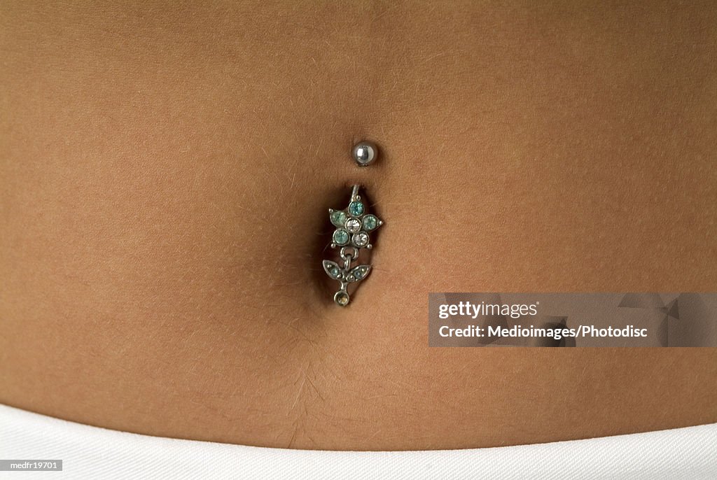 Close-up of a piercing in the navel