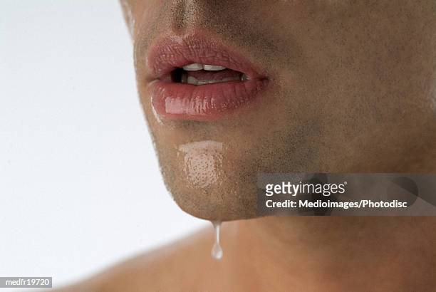 close-up of a man's mouth - damp lips stock-fotos und bilder