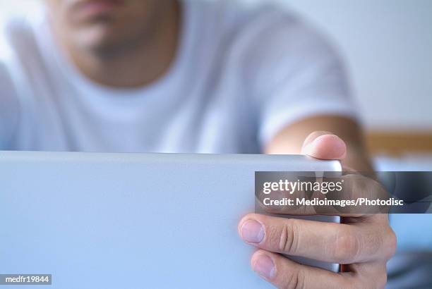 close-up of a man's fingers opening a laptop - closing laptop stock pictures, royalty-free photos & images