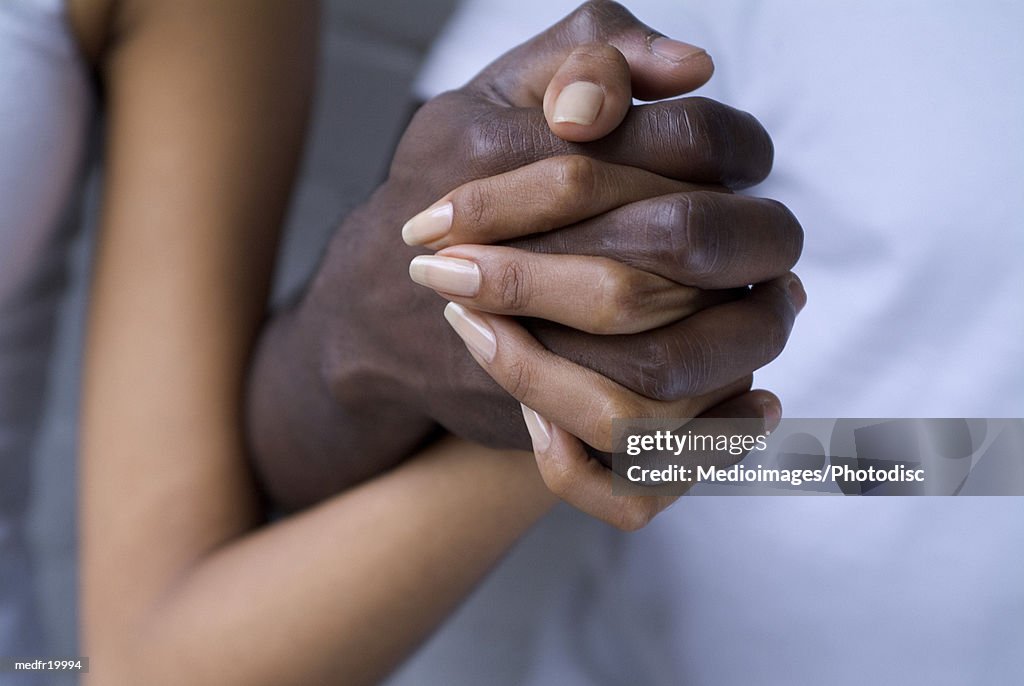 Close-up of human hands clasped together