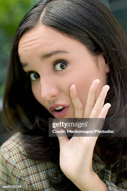 portrait of a young woman making a face - scheitel stock-fotos und bilder