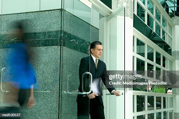 businessman opening a door - the opening day of goodwood races march 24 2004 stockfoto's en -beelden