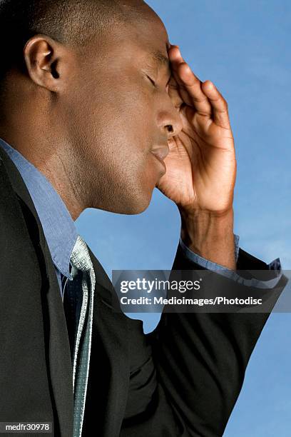 businessman outdoors with hand on forehead, close-up - hand on head ストックフォトと画像