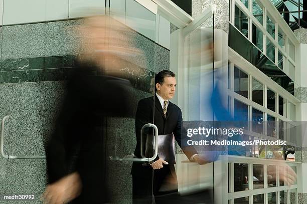 businessman opening a door - the opening day of goodwood races march 24 2004 stockfoto's en -beelden