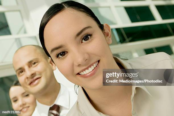 portrait of three business executives smiling - hair parting stockfoto's en -beelden