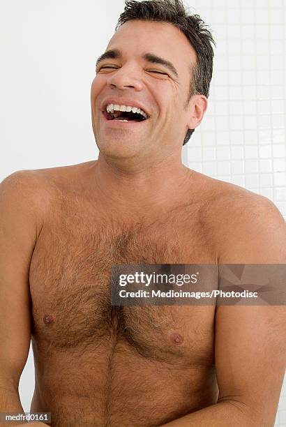 bare-chested laughing man in bathroom - brusthaar stock-fotos und bilder