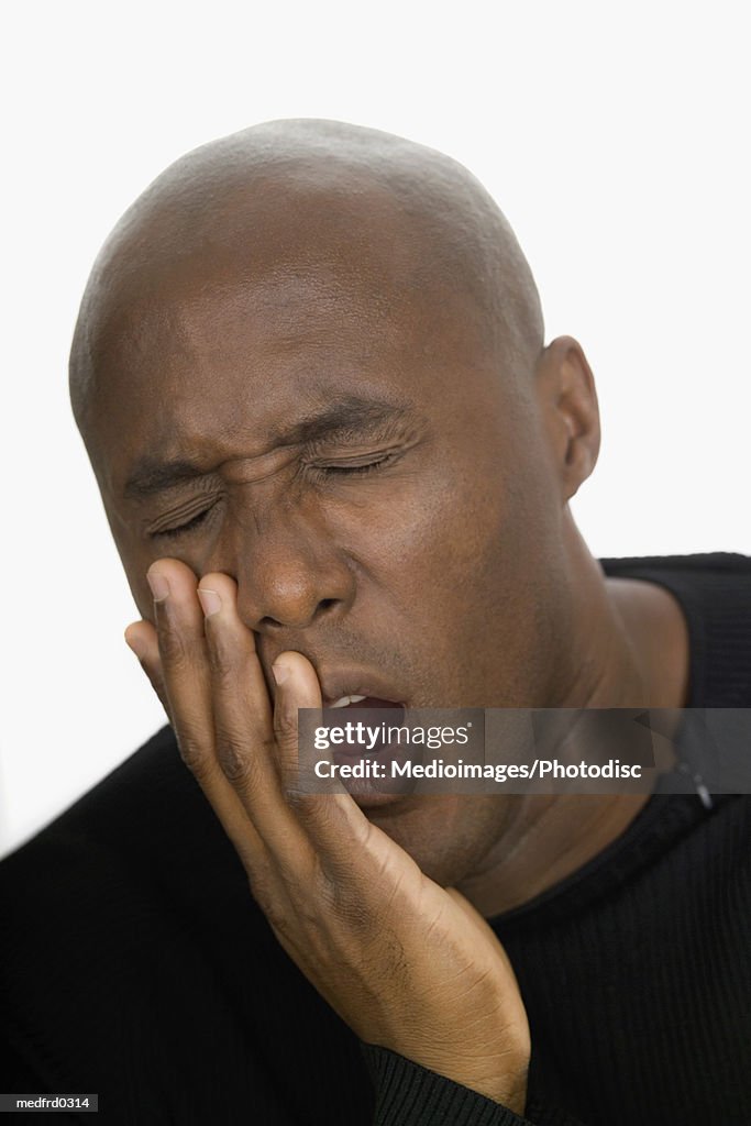 Portrait of bald man with toothache, close-up