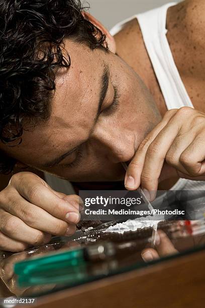 close-up of a man inhaling cocaine with a glass straw - snorted stock pictures, royalty-free photos & images