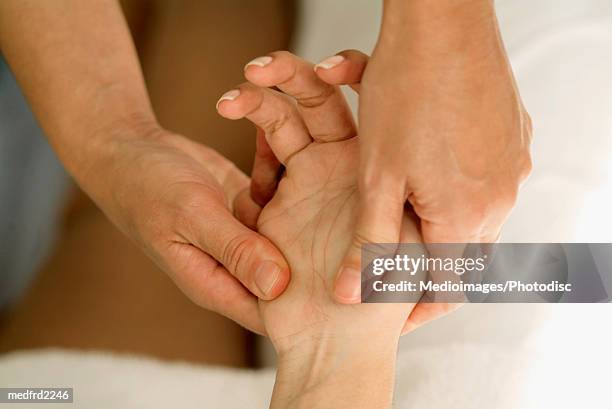 person massaging a hand - hand massage stock pictures, royalty-free photos & images