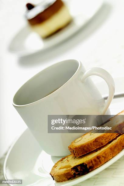 cup of coffee and nut bread on plate, with dessert in background, extreme close-up, tilt - bread dessert stock pictures, royalty-free photos & images