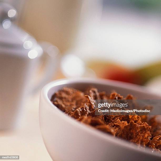 bowl of cereal with spoon and part of sugar bowl with lid, close-up, tilt - sugar bowl crockery stock pictures, royalty-free photos & images