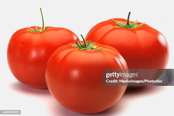 three tomatoes on counter, close-up - close up counter ストックフォトと画像