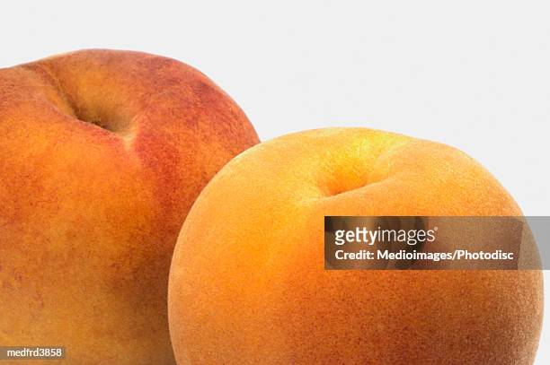 two peaches on counter, close-up - close up counter ストックフォトと画像